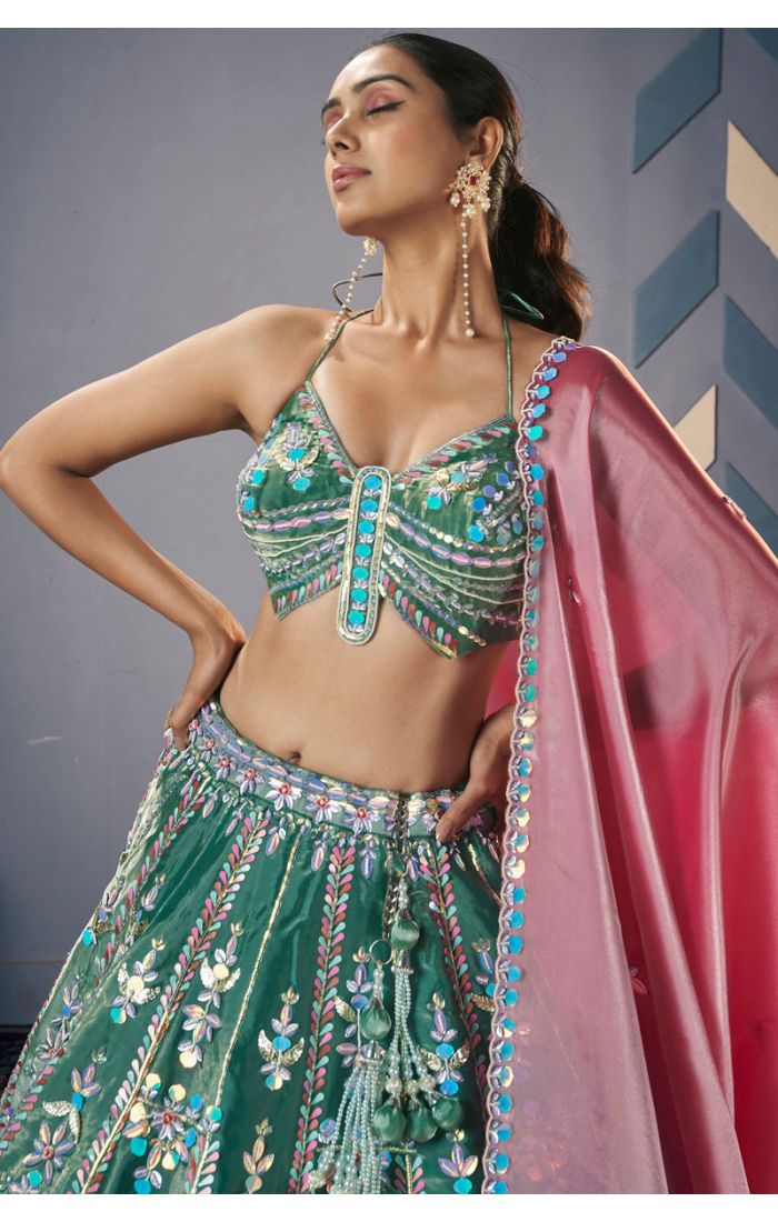 Emerald green designer lehenga choli with halter blouse and pink dupatta close-up — Appelle Fashion UK