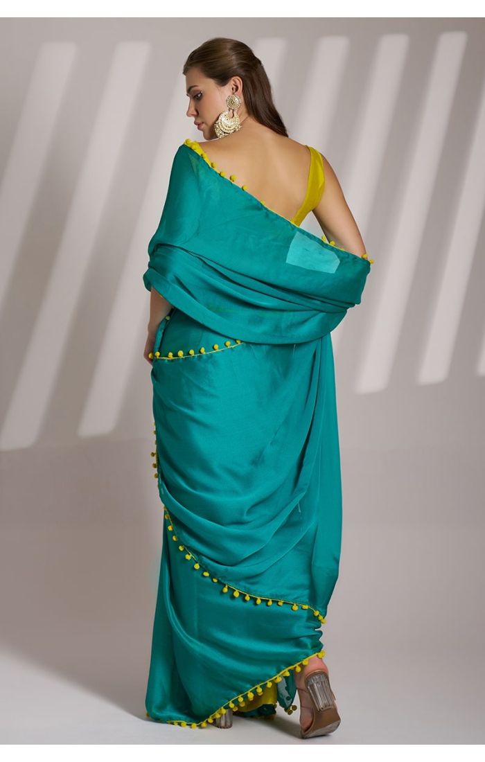 Emerald Green Chiffon Saree with Mustard Yellow Blouse and Pom-Pom Detailing – Perfect for Weddings and Festive Occasions