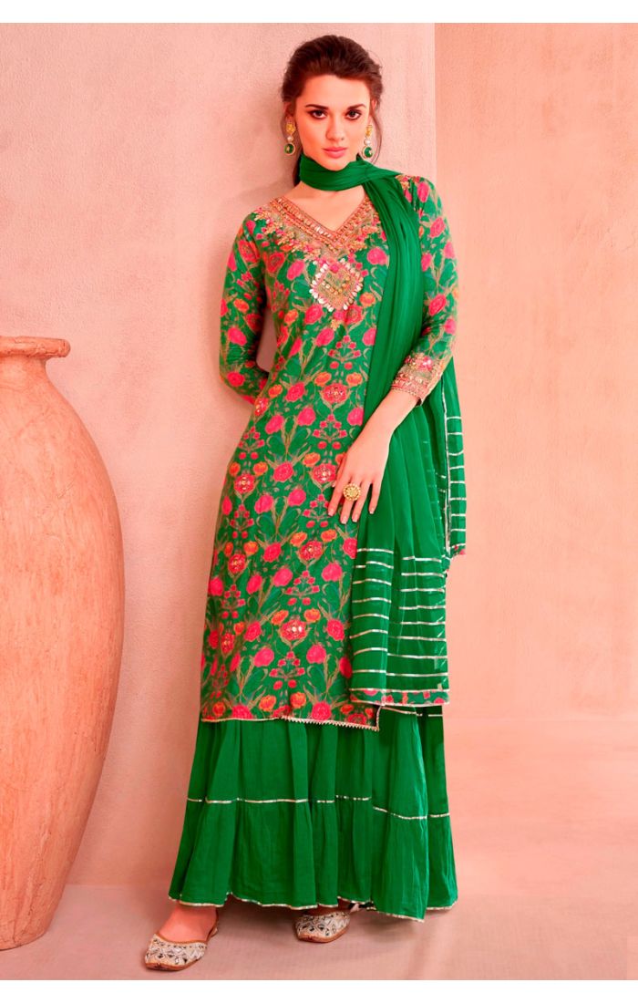 Model wearing green floral embroidered Anarkali suit with dupatta, ideal for weddings and festivals.