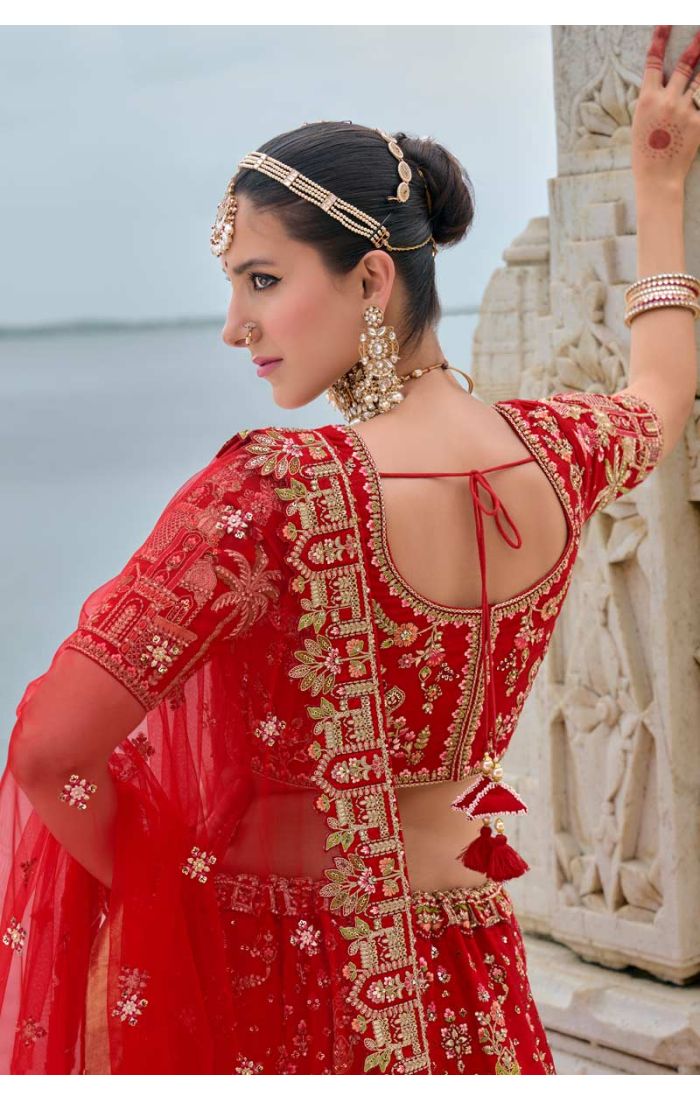 Exquisite red bridal lehenga with Zardosi embroidery and architectural design, ideal for weddings and special occasions. London, West.