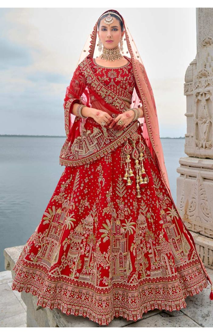 Exquisite red bridal lehenga with Zardosi embroidery and architectural design, ideal for weddings and special occasions.