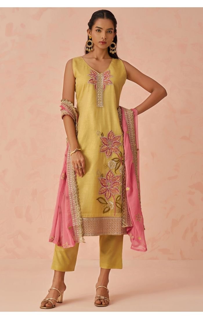  Full front pose of golden embroidered salwar kameez with pink dupatta styled for festive occasions — traditional Indian suit.