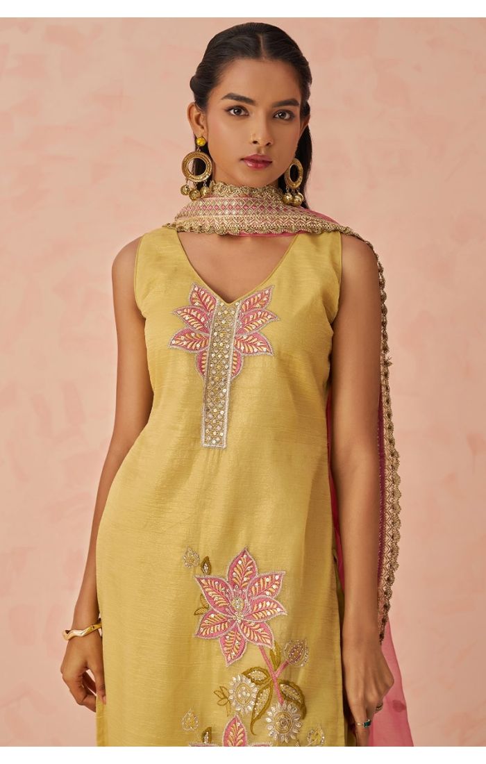  Close-up of golden Fancy Crush Silk kameez neckline embroidery and pink chiffon dupatta, showcasing fine detailing.