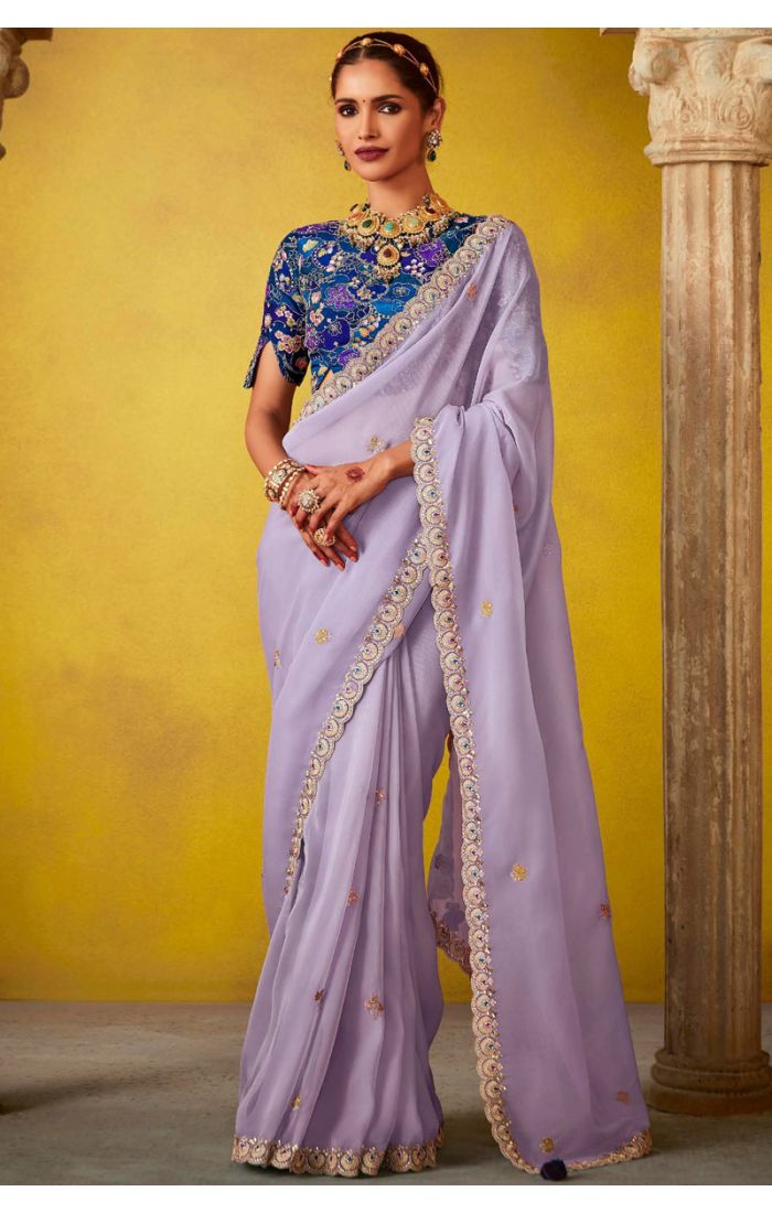 Lavender georgette saree with golden embroidery and vibrant blue brocade blouse for Eid and festive occasions.