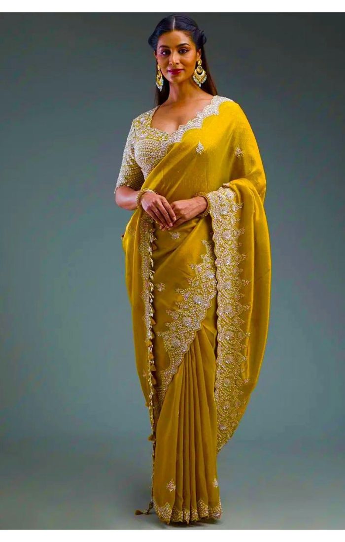  Woman wearing mustard silk crush saree with scalloped sequin border – front view