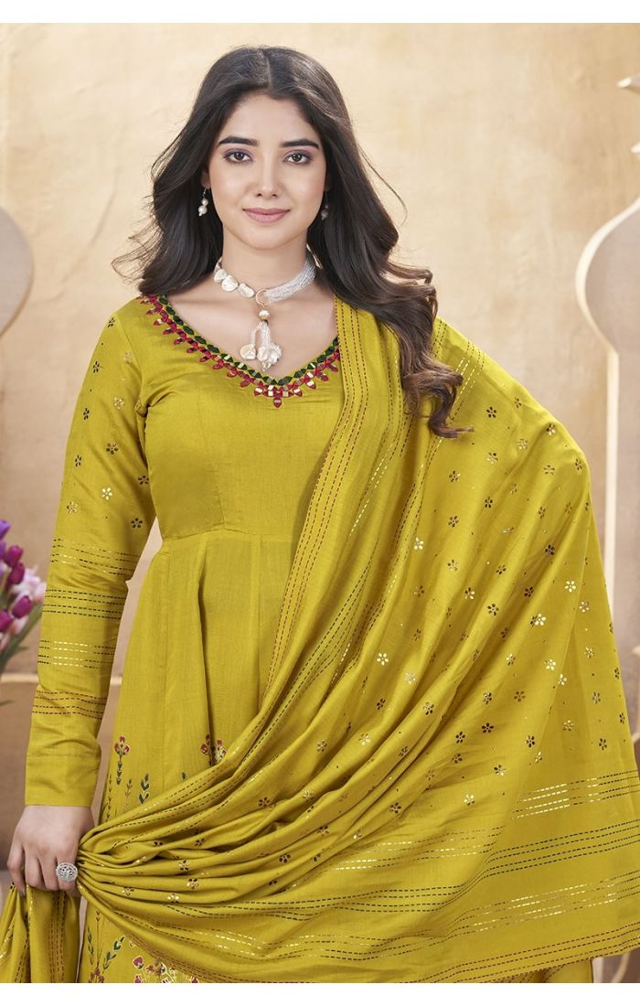 Mustard yellow embroidered palazzo suit with mirror work and tassel dupatta – perfect for weddings and festive occasions.