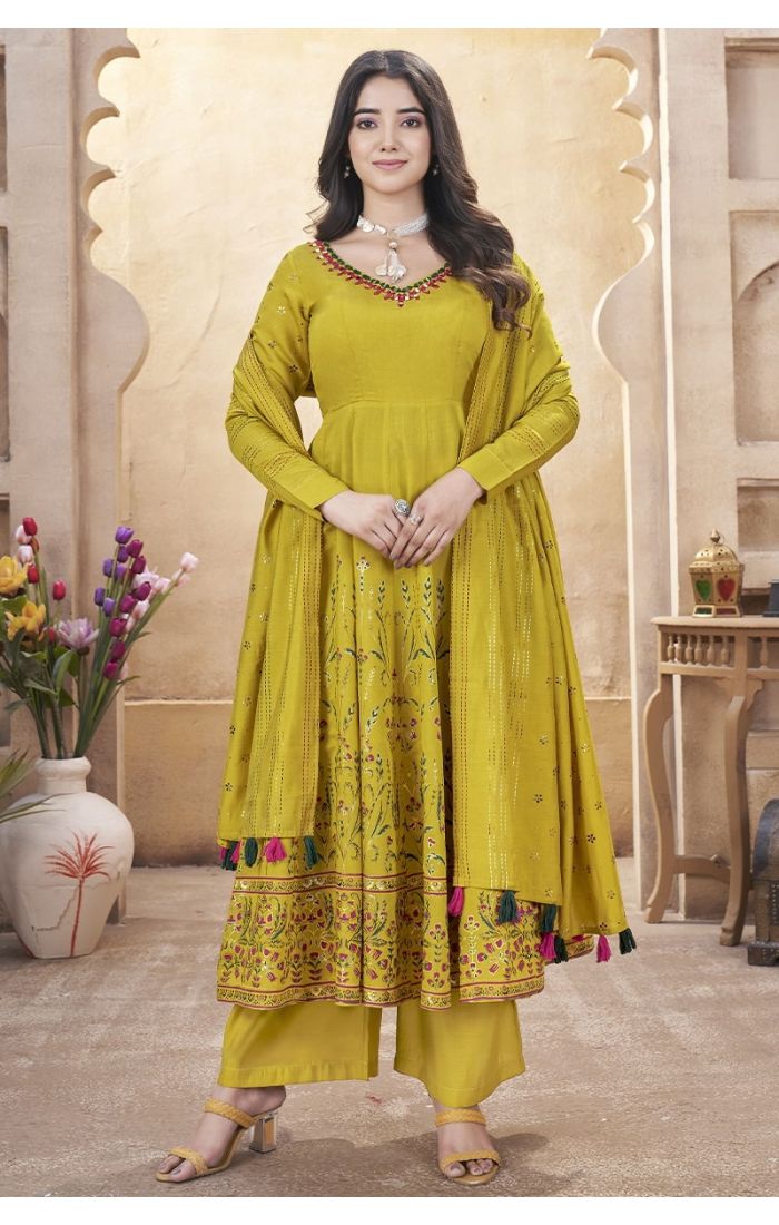 Mustard yellow embroidered palazzo suit with mirror work and tassel dupatta – perfect for weddings and festive occasions.