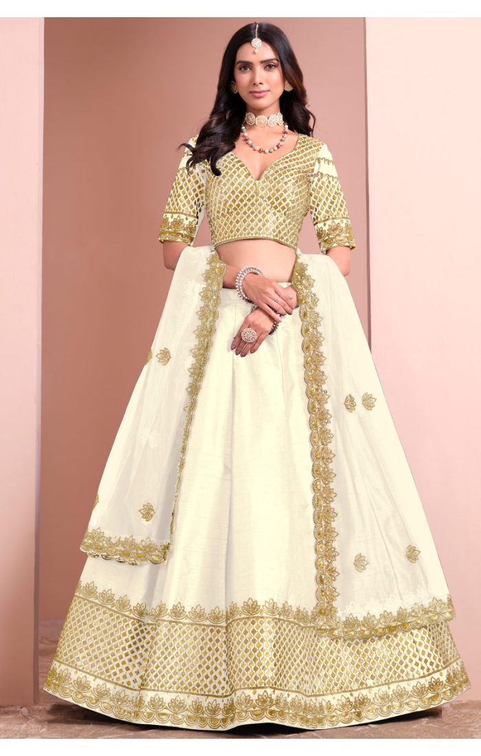 Off-white premium silk satin lehenga choli with gold embroidery and net dupatta — front view