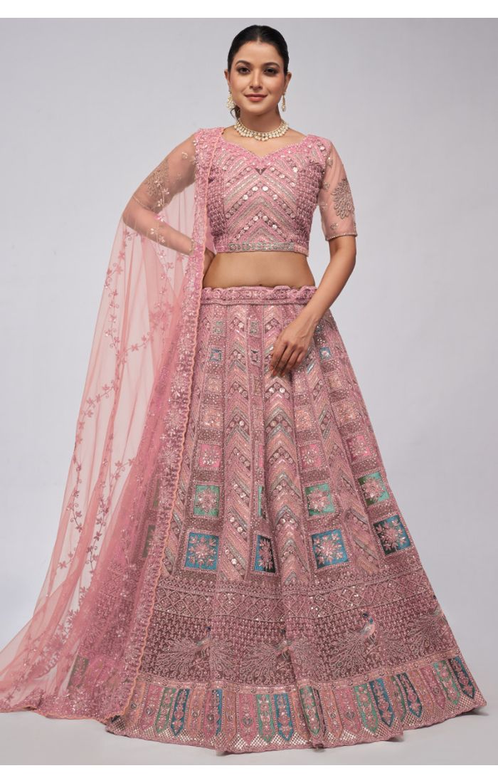 Pastel pink net embroidered wedding lehenga with intricate zari and sequins work, perfect for weddings and festive occasions.