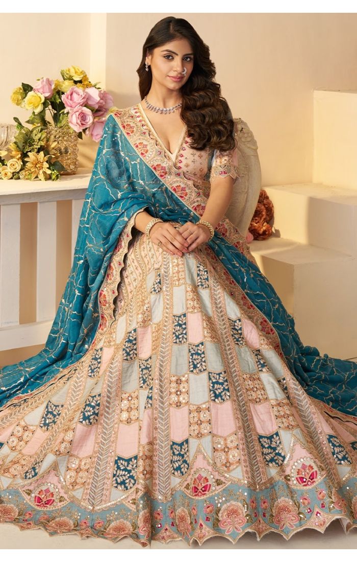 Front sitting view of powder blue jaal printed sequin Aari lehenga with dupatta