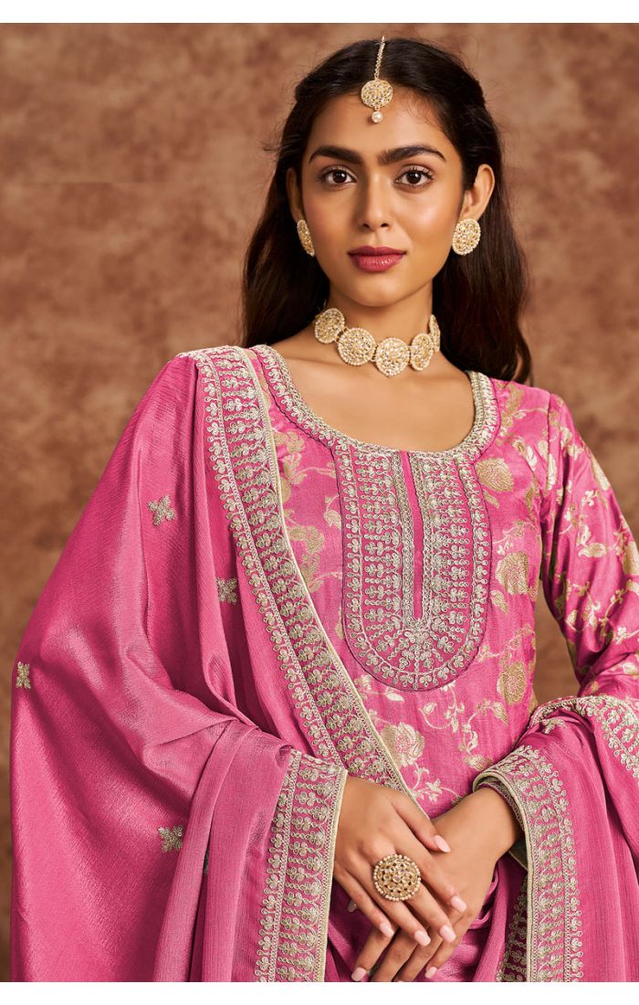 Close-up of premium pink silk salwar suit with intricate embroidery