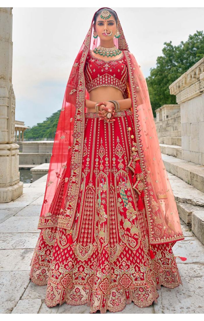 Red bridal lehenga with intricate Zardosi embroidery work, ideal for UK weddings, featuring designer craftsmanship and traditional elegance.