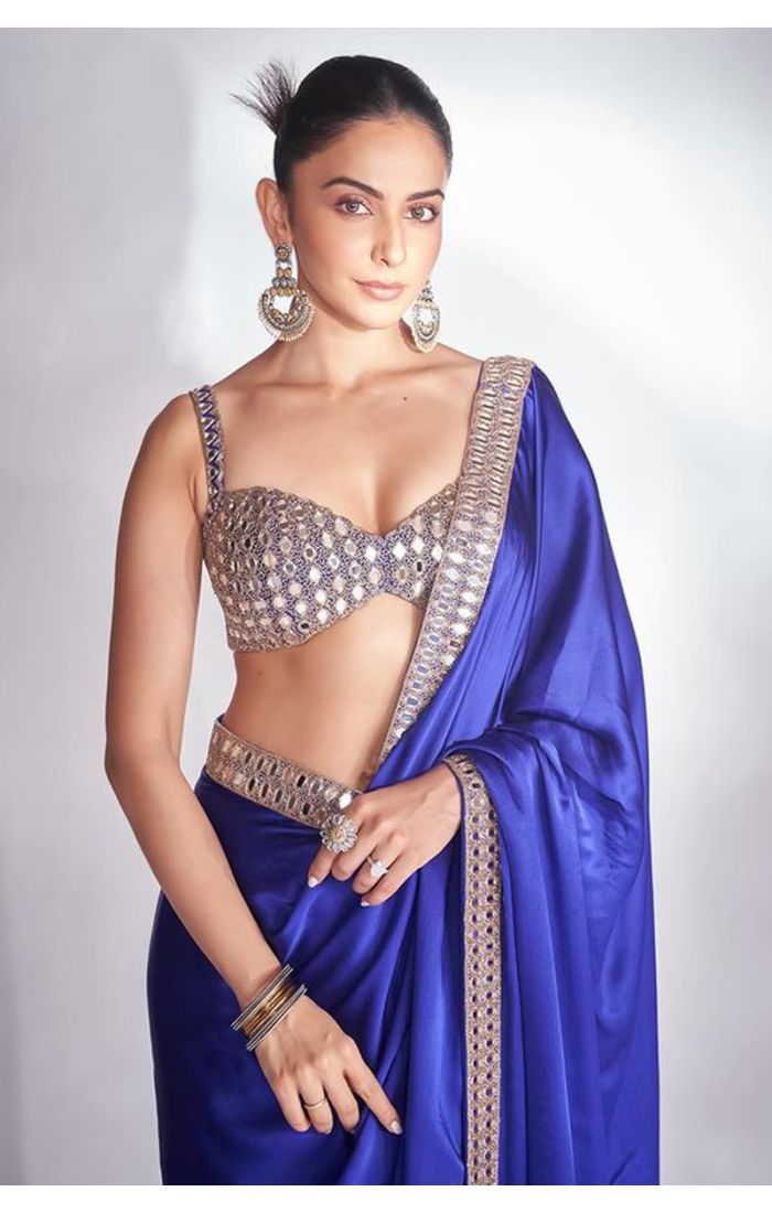 A stunning royal blue satin saree paired with an intricately embellished blouse, ideal for weddings and festive celebrations, available at Appelle Fashion.