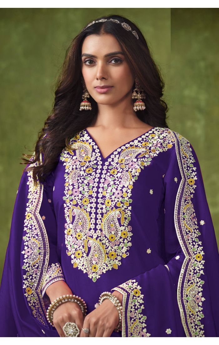 Close-up of embroidered neckline and dupatta on purple Punjabi salwar suit.