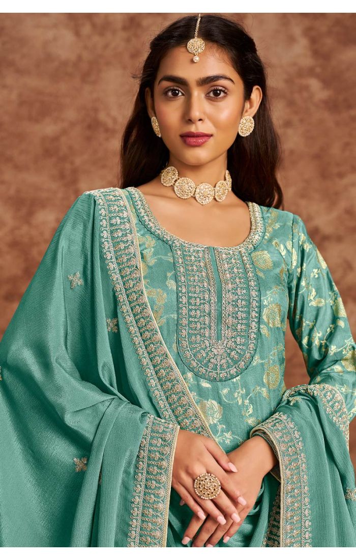 Close-up of teal green premium silk embroidered salwar suit neckline and detailing